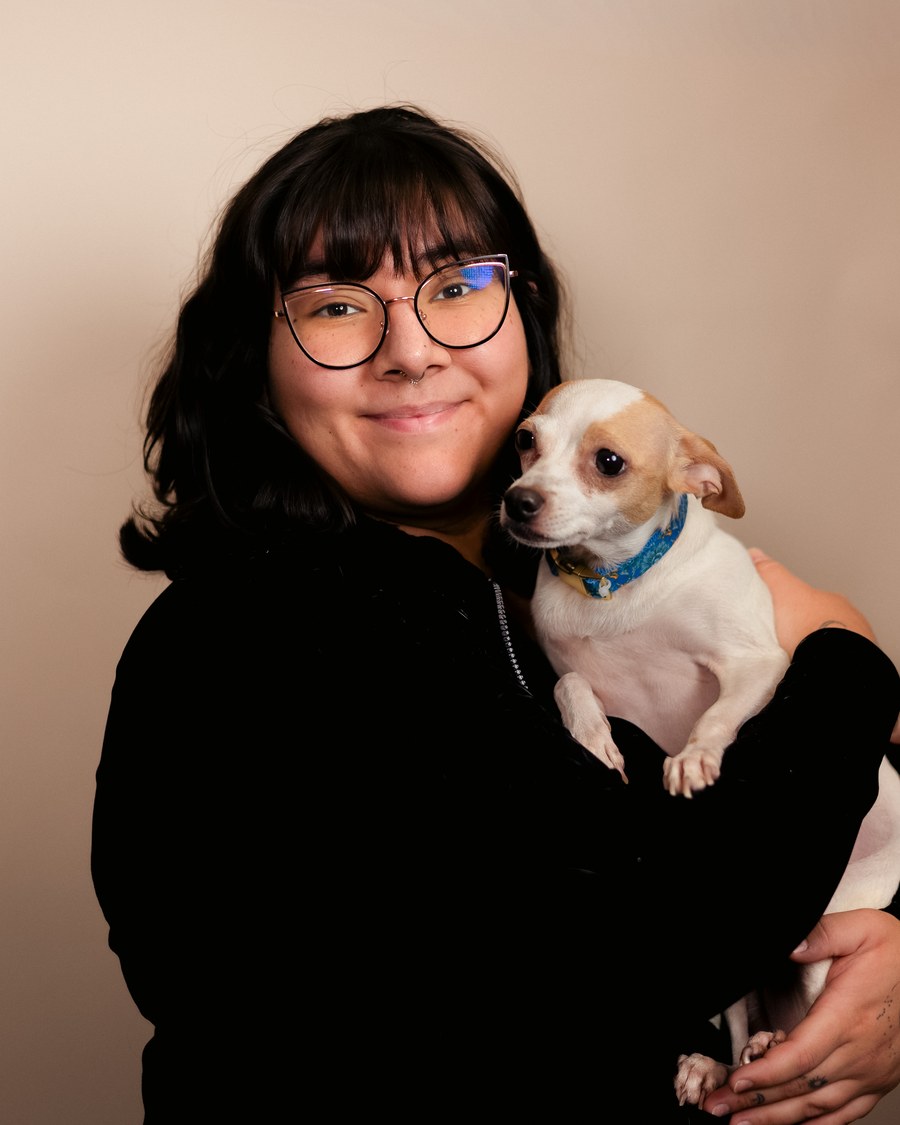 Jovani, veterinary technician at Oracle 77 Pet Clinic in Tucson, holding a chihuahua